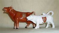 Souvenir cow creamers from Guernsey and Jersey