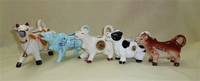 Five souvenir cow creamers from the US