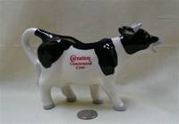 Black and white cow creamer advertising Carnation