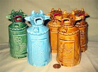 Five ceramic moo=cow-like creamers