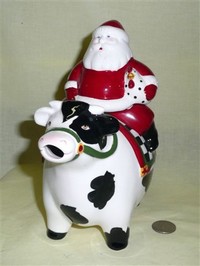 Santa carrying chicken cow teapot