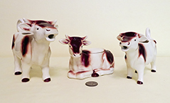 Two brown and white Goebel cow creamers and a sugar