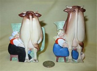 Two multicolored S&V pitchers of cow caricature being milked, back