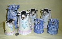 A small herd of S&V standing lady in a dress cow creamers