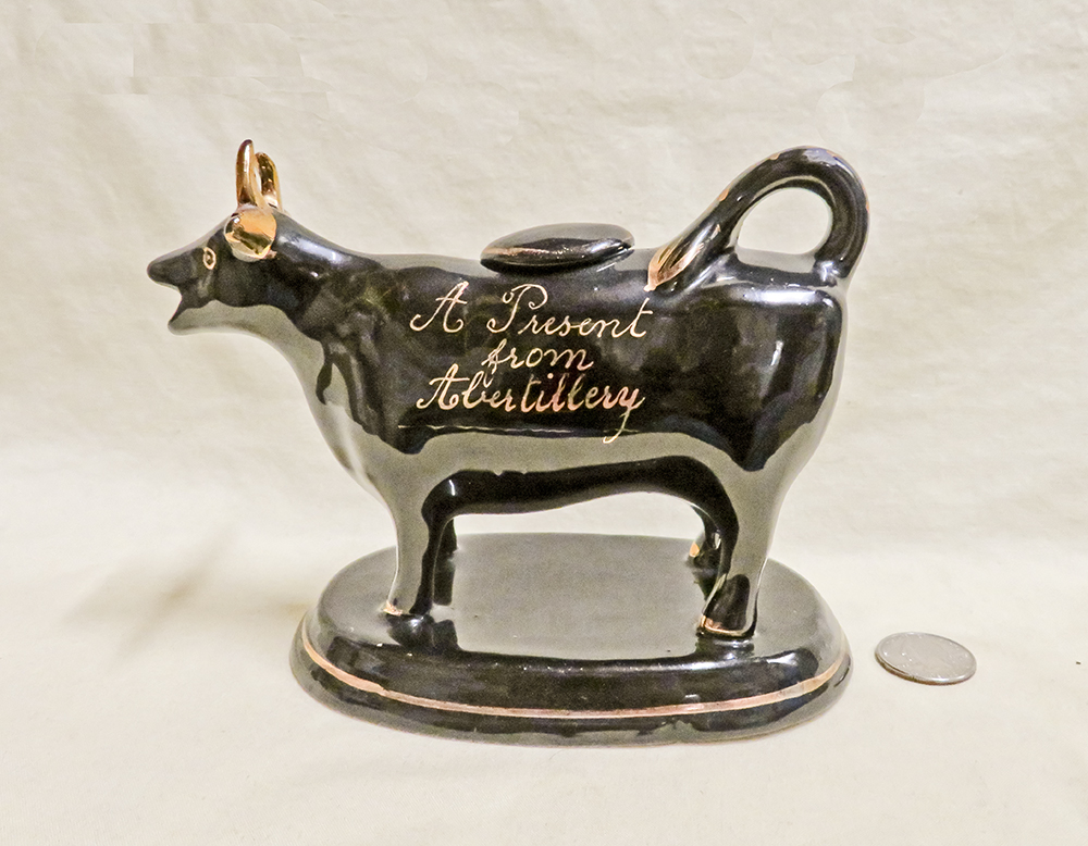 Jackfield souvenir cow creamer from Abertillery, left