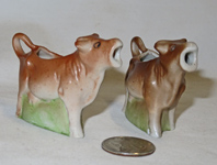 Two small German cow creamers on bases