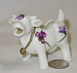 Small porcelain cow creamer with violets