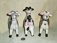 Three Elsie 'knock-off' cow creamers