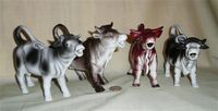 Four German realistic vintage porcelain cow creamers