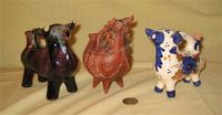 Three small bull cruets