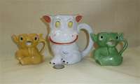 German cow pitcher and two small goblin creamers