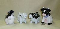 Four black & white cow creamers