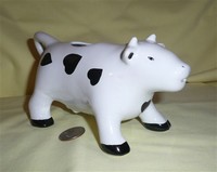 White cow creamner with black heart shaped spots