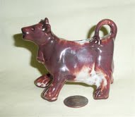 Purple, red clay cow creamer from UK