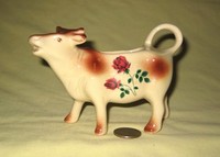 Brown and white cow creamer with flowers