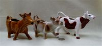 Three brown and white cow creamers