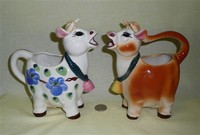 Two UCAGCO cow caricature creamers, side