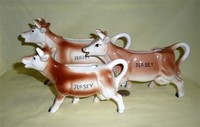 Three brown and whIte cow creamers marked for JERSEY