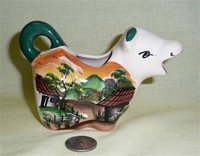 Small cow creamer with Chinese scene