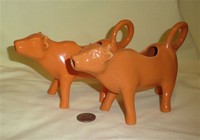 Pair of melon cow creamers by Traders and Company