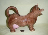 Brown cow creamer with large udder and green fish inside, side