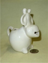 Weird white caricature cow creamer from UK