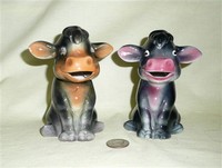 Two sitting up cow caricature creamers with big ears