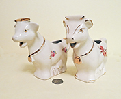 2 similar large headed filled below cow creamers 