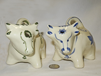 Two Welsh cow creamers with pour holes on their foreheads