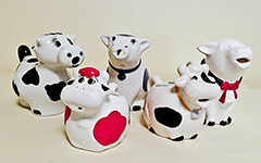 5 small round cow creamers