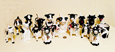 Herd of black and white cow creamers