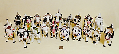 Herd of  black and white cow creamers