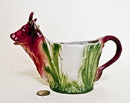 Cup-like cow creamer with brown head and tail