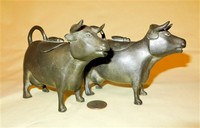 Two pewter cow creamners
