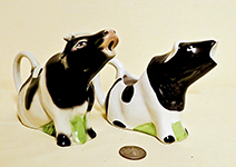 2 sitting British cow creamers, one by Tony Wood