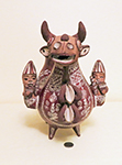 Peruvian Bull jug with two human heads beside, front