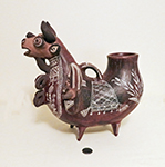 Peruvian Bull jug with two human heads beside, side