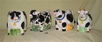 4 more large black and white cow pitchers