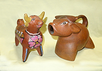 Two Mexican clay cow jugs