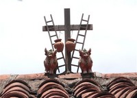 Toritos de Pucara and jugs on Peruvian tile roof