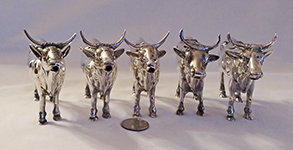 5 similar silver cow creamers, front