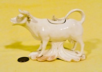 White ceramic cow creamer with plinth under belly