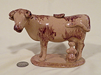 Yellowish cow creamer with brown sponging and milkmaid