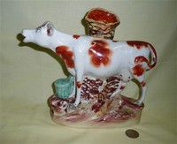 Large cow creamer spill vase with green bucket, side