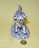 Long necked cow creamer with blue flowers, front