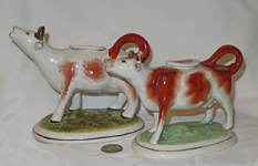 Pair of briown cow creamers with long nacks and raised heads