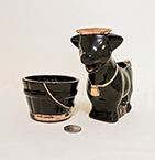 Black and gold cow with similar sugar bucket