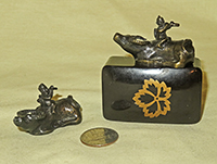 Two Japanese bronze boy with flute on water buffaly suiteki