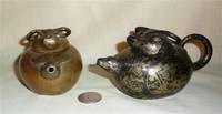 Two small metal Chinese teapots with water buffalo heads for spouts and lids
