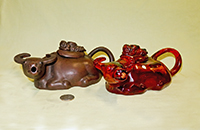 Chinese red clay and plastic amber water buffalo teapots with napping boys on lids